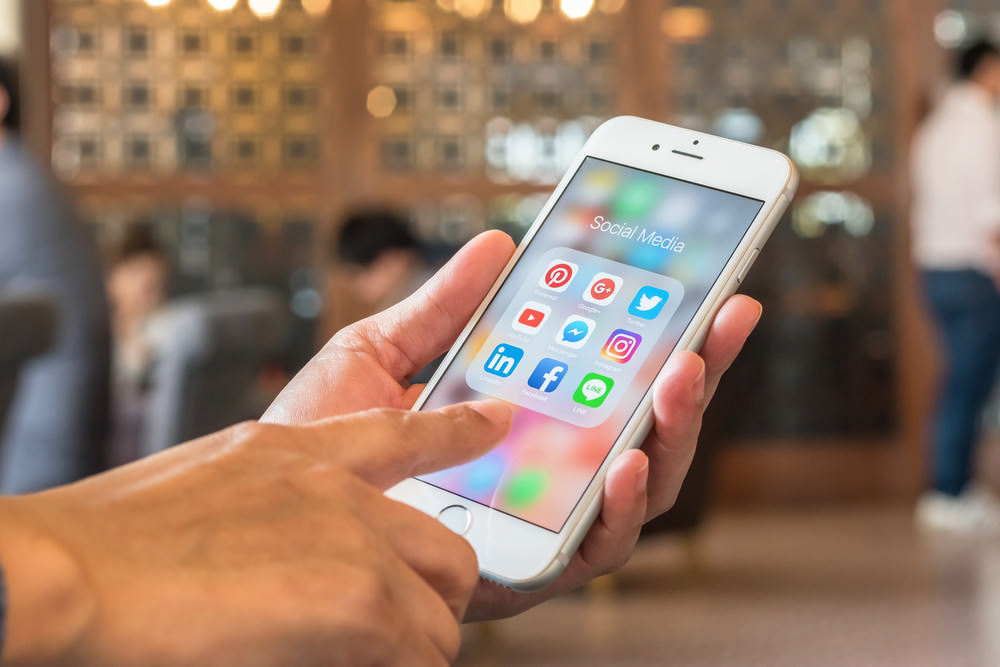 People making purchase via social channel on iPhone